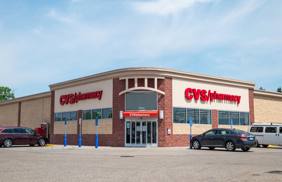 BEMIDJI, MN - 3 JUN 2023: CVS Pharmacy building and parking lot with vehicles.