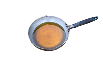 Old or used vegetable oil in the pan. Isolated on white background.