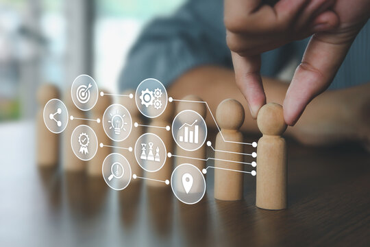 Hand choose wooden doll stand out first the group concept of leadership relationship or HR human resources officer or business team and personnel management job performance.