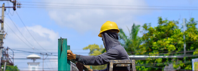 
construction workers wearing safety helmets are working at height