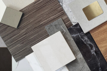 close up view of interior materials sample including black and gery marble stones, wooden vinyl...