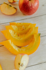 ripe apples and orange pumpkin on a light background. natural food. a healthy snack. vegetarian food