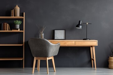 minimalistic home workplace with wooden desk and a dark grey wall