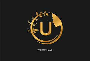 Naklejka premium Beauty logo initial letter U with golden style color and leaf. Natural beauty logo template
