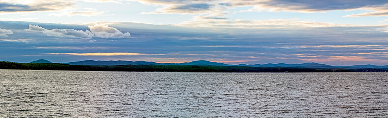 cloudy sky over evening lake in mountainous area, Southern Urals