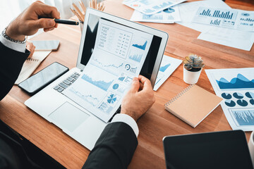 Fototapeta na wymiar Diverse group of business analyst team analyzing financial data report paper on office table. Chart and graph dashboard by business intelligence analysis for strategic marketing planning Habiliment