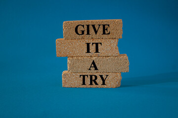 Give it a try symbol. Concept word Give it a try on beautiful brick blocks. Beautiful blue background. Business give it a try concept. Copy space.