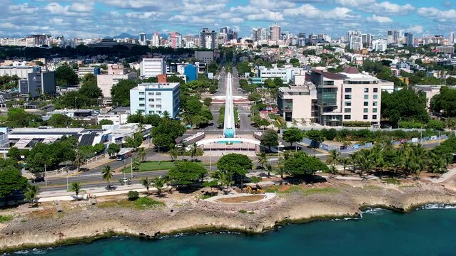 Aerial cinematic footage of the city of Santo Domingo, Capital Of Dominican Republic, its beautiful streets and buildings, la Fuente Centro de los Heroes, the Pabellón de las Naciones