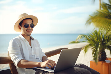 happy man working remotely on laptop on summer vacation - nomadic remote work concept