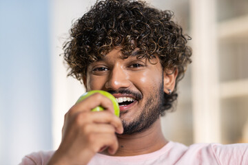 A face of positive smiling mestizo guy in joyful and happy mood. A young charming african or...