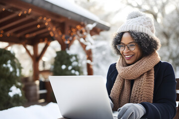 happy senior black woman working remotely on laptop on winter vacation - Powered by Adobe