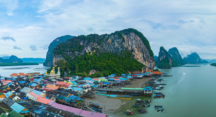 Aerial view Colorful house roofs on a village on Koh Panyee..amazing village on sea water..The natives densely planted their living quarters on the island..Colorful house roofs on a village.