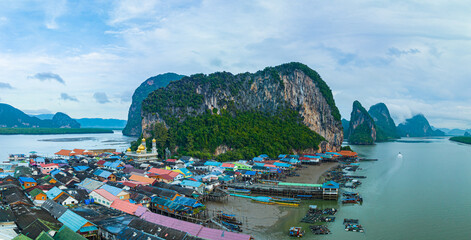 Aerial view Colorful house roofs on a village on Koh Panyee..amazing village on sea water..The...