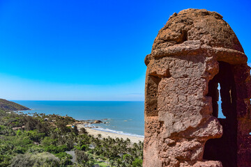 Fortress tower in Fort Chapora. In the background is a view of the beaches of Anjuna and Vagator in...