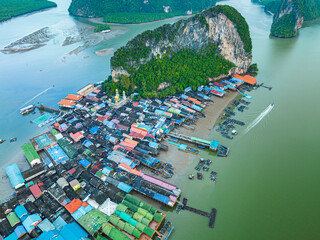 Aerial view Colorful house roofs on a village on Koh Panyee..amazing village on sea water..The natives densely planted their living quarters on the island..Colorful house roofs on a village.