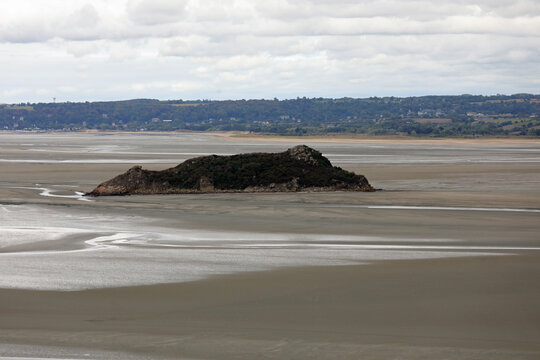view from Mont Saint Michel Abbey in Normandy in Northern France and the islet during low tide