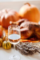 Delicious golden roasted Thanksgiving turkey on dinner table with pumpkins
