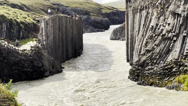 River streaming in the middle of a basaltic Canyon in Iceland