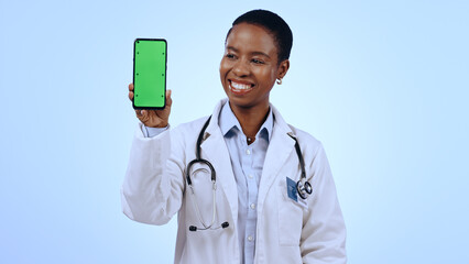 Green screen, black woman and doctor with a cellphone, healthcare or professional on blue background. African person, medical or physician with smartphone, tracking markers or promotion with medicare