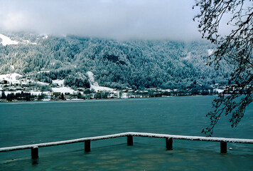 view across the partly frozen Ossiacher lake on a dull winter day in Carinthia, Austria