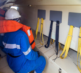 sailor inside a life boat during a drill