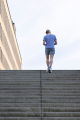 Young man climbing stairs. Line pattern. Street photography. Minimalism. - 676717518