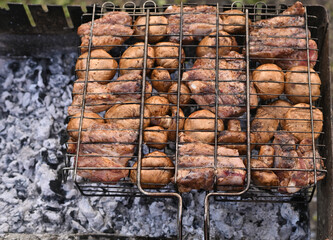 Pork ribs with mushrooms are cooked on the grill
