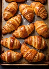 Delicious buttery croissants prepared on a baking sheet. Generative AI.