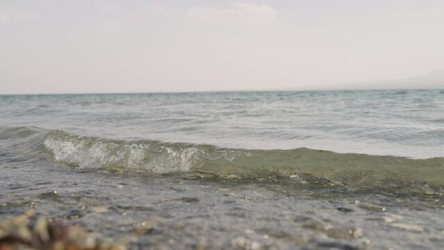 Slow motion closeup shot of clear water waves of a lake