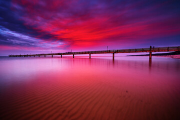 powerful afterglow at baltic sea pier of Lubmin - obrazy, fototapety, plakaty