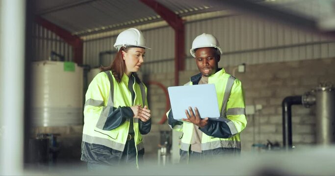Laptop, industry and construction worker team in a warehouse for planning or discussion. Diversity, communication or collaboration with an engineer and designer together in a plant for manufacturing