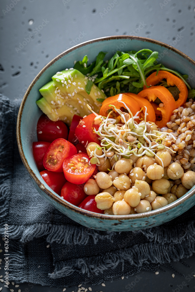 Wall mural fresh salad with chickpeas, pepper, avocado and groats.