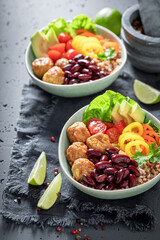 Healthy Mexican salad with meatballs, beans, groats and pepper.