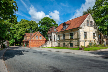 Naklejka premium View of the street in Kuldiga with old house and stone road. Latvia. Kuldiga is included in the UNESCO World Heritage List.