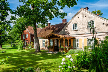 Old house in the heart of Kuldiga with nice garden view and the old carved entrance. Latvia. Kuldiga is included in the UNESCO World Heritage List.