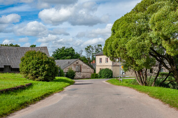 Country road with a traffic sign indicating change of main direction.