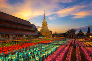 Lantern Festival or Yi Peng Festival in Hundred Thousand Lanterns is the big event of the popular Loi Krathong Festival at Wat  Phra That Hariphunchai Temple Lamphun a famous place Thailand, Asia. - obrazy, fototapety, plakaty