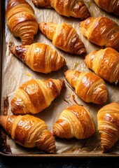 Delicious buttery croissants prepared on a baking sheet. Generative AI.
