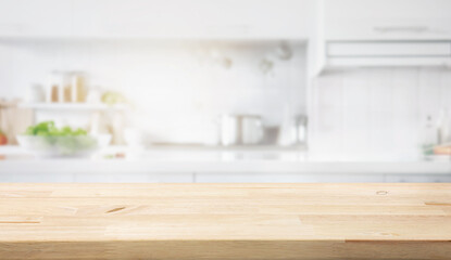 Selective focus.Wood table top on blur kitchen counter in morning background.For montage product...