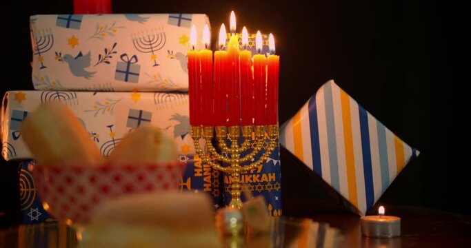 Hanukkah food and decorations in candlelight