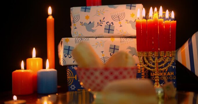 Hanukkah food and decorations in candlelight