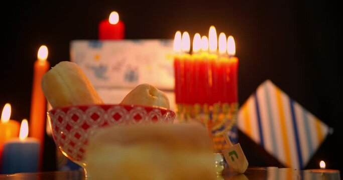 Hanukkah food and dreidels in dim light