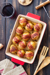 Baked potatoes with bacon and thyme. Homemade food.