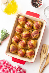 Baked potatoes with bacon and thyme. Homemade food.