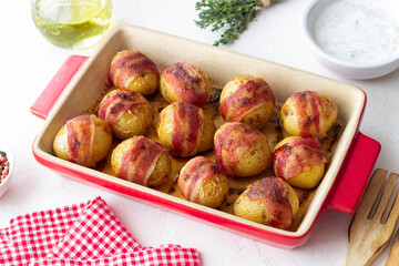 Baked potatoes with bacon and thyme. Homemade food.