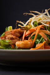Close up photo of Seafood salad with shrimp, salmon, and fresh vegetables