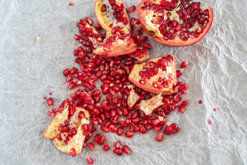 Peeled pomegranate fruit on textured paper.
