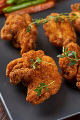 Fried chicken wings with sauteed vegetables