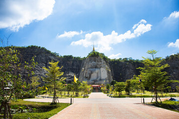 Sculpture carving big buddha carving on stone cliff mountain Wat Khao Tham Thiam for thai people...
