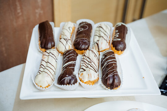 A set of delicious chocolate eclairs with cream filling, a sweet treat, a dessert table.